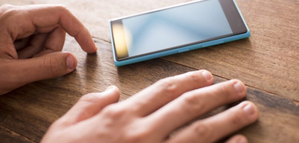 Man waiting for contact on his mobile phone